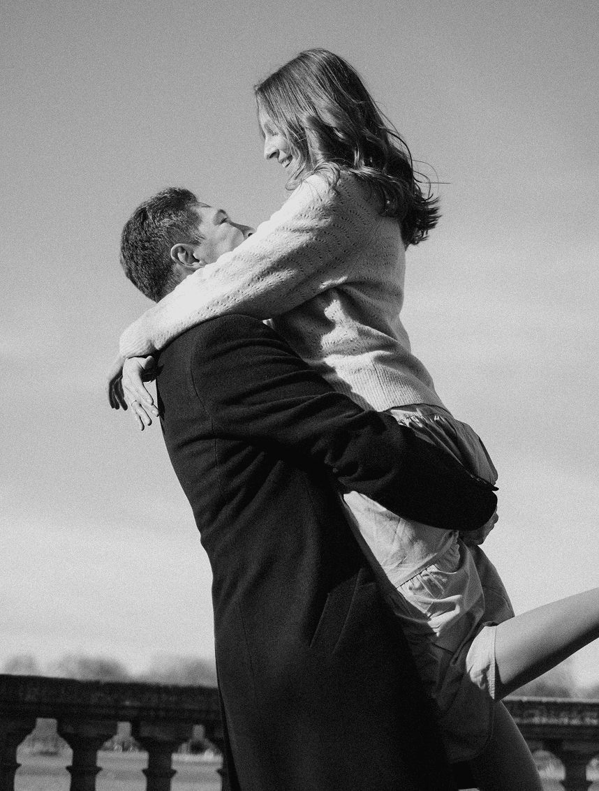 Happy moment of a man lifting a woman in his arms captured in black and white