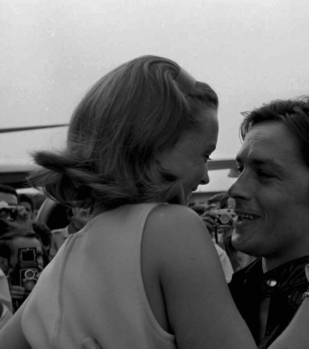Vintage black and white photo of a couple embracing at a public event