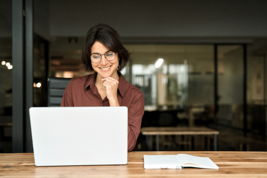 A happy, professional businesswoman working in her office